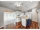 Open concept kitchen and living area with white cabinets and hardwood flooring at 901 W 250 N, Lebanon, IN 46052