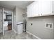 Laundry room features tile floor, cabinets, and washing machine at 901 W 250 N, Lebanon, IN 46052