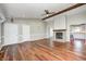 Spacious living room with a fireplace, wood beam, and hardwood floors at 901 W 250 N, Lebanon, IN 46052