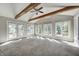 Bright sunroom with vaulted ceilings, wood beams, and multiple windows with a view at 901 W 250 N, Lebanon, IN 46052