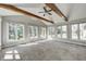 Sun-filled room with vaulted ceilings, wood beams, and multiple windows with nature views at 901 W 250 N, Lebanon, IN 46052