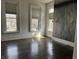 Bedroom with hardwood floors, large windows, and neutral wall decor at 902 N Broadway St, Indianapolis, IN 46202