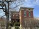 Charming brick house featuring detailed architectural trim, including corbels, dentil molding, and detailed windows at 902 N Broadway St, Indianapolis, IN 46202