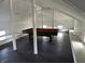 Spacious game room with a pool table and natural light at 902 N Broadway St, Indianapolis, IN 46202