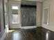 Spacious living room with dark hardwood floors and modern lighting fixtures at 902 N Broadway St, Indianapolis, IN 46202