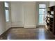 Empty room featuring hardwood floors, natural light, and potential for customization and personalization at 902 N Broadway St, Indianapolis, IN 46202
