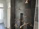 Walk-in shower with multiple shower heads and dark slate tile at 902 N Broadway St, Indianapolis, IN 46202