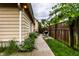 Cozy backyard featuring a well-kept lawn, wooden fence, and a charming walkway lined with blooming flowers at 902 Villa Ave, Indianapolis, IN 46203