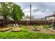 Overhead shot of a backyard with a wooden fence, small garden, fire pit and open green space at 902 Villa Ave, Indianapolis, IN 46203
