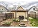 Charming backyard oasis with a pergola-shaded dining area, a cozy fire pit, and flourishing spring daffodils at 902 Villa Ave, Indianapolis, IN 46203