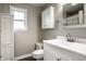 Clean bathroom with a white vanity, linen storage, and neutral wall color at 902 Villa Ave, Indianapolis, IN 46203