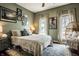 Comfortable bedroom with olive green walls, layered rugs, and natural light at 902 Villa Ave, Indianapolis, IN 46203