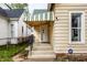 A covered front porch entry with security features, and an awning above the door at 902 Villa Ave, Indianapolis, IN 46203