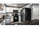 Updated kitchen featuring black appliances, granite countertops, and white cabinets at 902 Villa Ave, Indianapolis, IN 46203