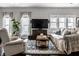 Inviting living room with hardwood floors, neutral decor, and modern entertainment center at 902 Villa Ave, Indianapolis, IN 46203