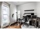 Home office with a large window, hardwood floors, and modern furniture at 902 Villa Ave, Indianapolis, IN 46203