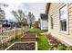 A side yard with multiple tiered garden beds with rich, dark soil at 902 Villa Ave, Indianapolis, IN 46203