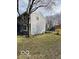 Side view of home backyard with a trampoline and mature tree, offering a private outdoor space at 9235 Thrushwood Ln, Indianapolis, IN 46250
