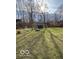 Large backyard featuring a storage shed, a swing set, and ample open space for recreation and leisure at 9235 Thrushwood Ln, Indianapolis, IN 46250