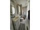 A full bathroom with tub and shower combination and a gray vanity with a large oval mirror at 9235 Thrushwood Ln, Indianapolis, IN 46250