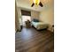 This bedroom features dark wood floors and a ceiling fan, with plenty of natural light from the window at 9235 Thrushwood Ln, Indianapolis, IN 46250