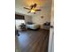 This bedroom features dark wood floors and a ceiling fan, with plenty of natural light from the window at 9235 Thrushwood Ln, Indianapolis, IN 46250