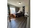 Bright bedroom featuring a twin bed, a large window, and built-in shelving for efficient storage at 9235 Thrushwood Ln, Indianapolis, IN 46250