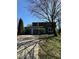 Charming two-story home featuring a two-car garage and landscaped front yard with mature tree at 9235 Thrushwood Ln, Indianapolis, IN 46250