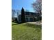 Exterior of home with green lawn and mature landscaping, showcasing curb appeal and outdoor space at 9235 Thrushwood Ln, Indianapolis, IN 46250