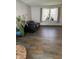 Bright living room featuring wood-look tile floors and ample natural light at 9235 Thrushwood Ln, Indianapolis, IN 46250