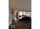 Open-concept living room featuring wood flooring and a black leather couch at 9235 Thrushwood Ln, Indianapolis, IN 46250