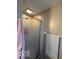 Bathroom with a clear glass shower door and gray tile details, showcasing modern fixtures and a clean design at 9235 Thrushwood Ln, Indianapolis, IN 46250