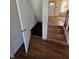 View of access to the basement with wood-look steps and adjacent living room at 930 Charlene Ln, Anderson, IN 46011