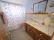 Bathroom featuring a vanity and a shower with a blue and white curtain at 930 Charlene Ln, Anderson, IN 46011