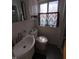 Cozy bathroom with modern sink, toilet, and colorful window dressing at 930 Charlene Ln, Anderson, IN 46011