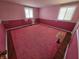 Bedroom with pink carpet and walls, featuring two windows at 930 Charlene Ln, Anderson, IN 46011