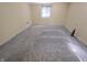 Bedroom with a large window, neutral-toned walls, and a lamp at 930 Charlene Ln, Anderson, IN 46011