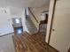 Inviting entryway with hardwood floors, carpeted stairs, and a bright front door at 930 Charlene Ln, Anderson, IN 46011