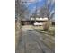 Two-story home featuring a brick facade, two-car garage, and a long, cracked driveway at 930 Charlene Ln, Anderson, IN 46011