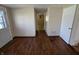 Hallway featuring wood floors, neutral walls, and access to multiple rooms at 930 Charlene Ln, Anderson, IN 46011