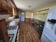 Efficient kitchen layout with plenty of cabinets, a breakfast bar, and durable laminate flooring at 930 Charlene Ln, Anderson, IN 46011