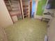 Unfurnished room with vintage green flooring and built-in shelving with storage at 930 Charlene Ln, Anderson, IN 46011