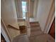 Carpeted staircase with white railing and wooden handrail at 930 Charlene Ln, Anderson, IN 46011