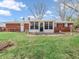 The backyard features a screened-in porch and a well-maintained lawn, perfect for outdoor activities at 9406 Northeastern Ave, Indianapolis, IN 46239