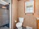 Cozy bathroom featuring a frosted glass shower and a classic white toilet at 9406 Northeastern Ave, Indianapolis, IN 46239