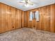 A wood-paneled bedroom featuring a window for natural lighting at 9406 Northeastern Ave, Indianapolis, IN 46239