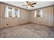 A room featuring a ceiling fan, windows, and striped wallpaper at 9406 Northeastern Ave, Indianapolis, IN 46239