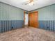 Bedroom featuring classic wallpaper, striped walls, and a closet at 9406 Northeastern Ave, Indianapolis, IN 46239