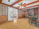 Inviting dining area with a brick fireplace, wood beams, and sliding glass doors at 9406 Northeastern Ave, Indianapolis, IN 46239