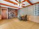 Comfortable dining room featuring a cozy brick fireplace and wood beam accents at 9406 Northeastern Ave, Indianapolis, IN 46239
